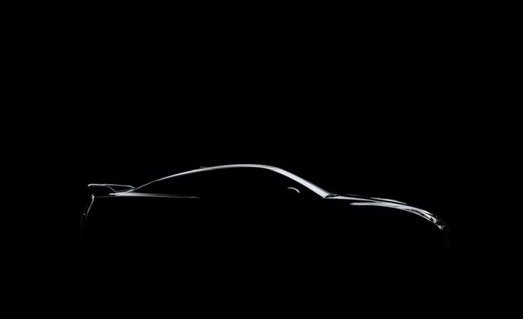 Black luxury sedan in a dimly lit showroom